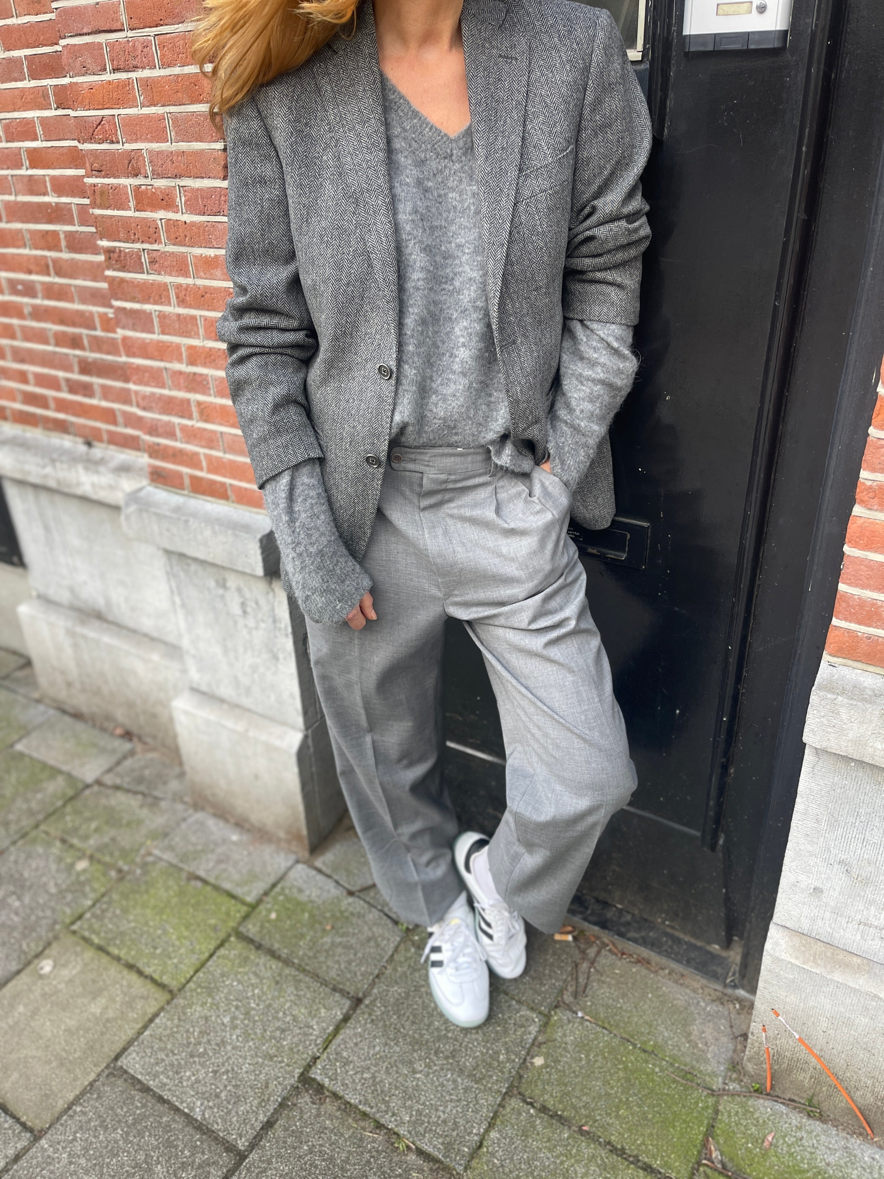 Light grey pleated pants.