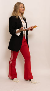 Fire red adidas track pants.
