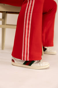 Fire red adidas track pants.