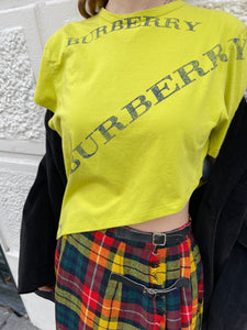 Asymmetric yellow Burberry tee.