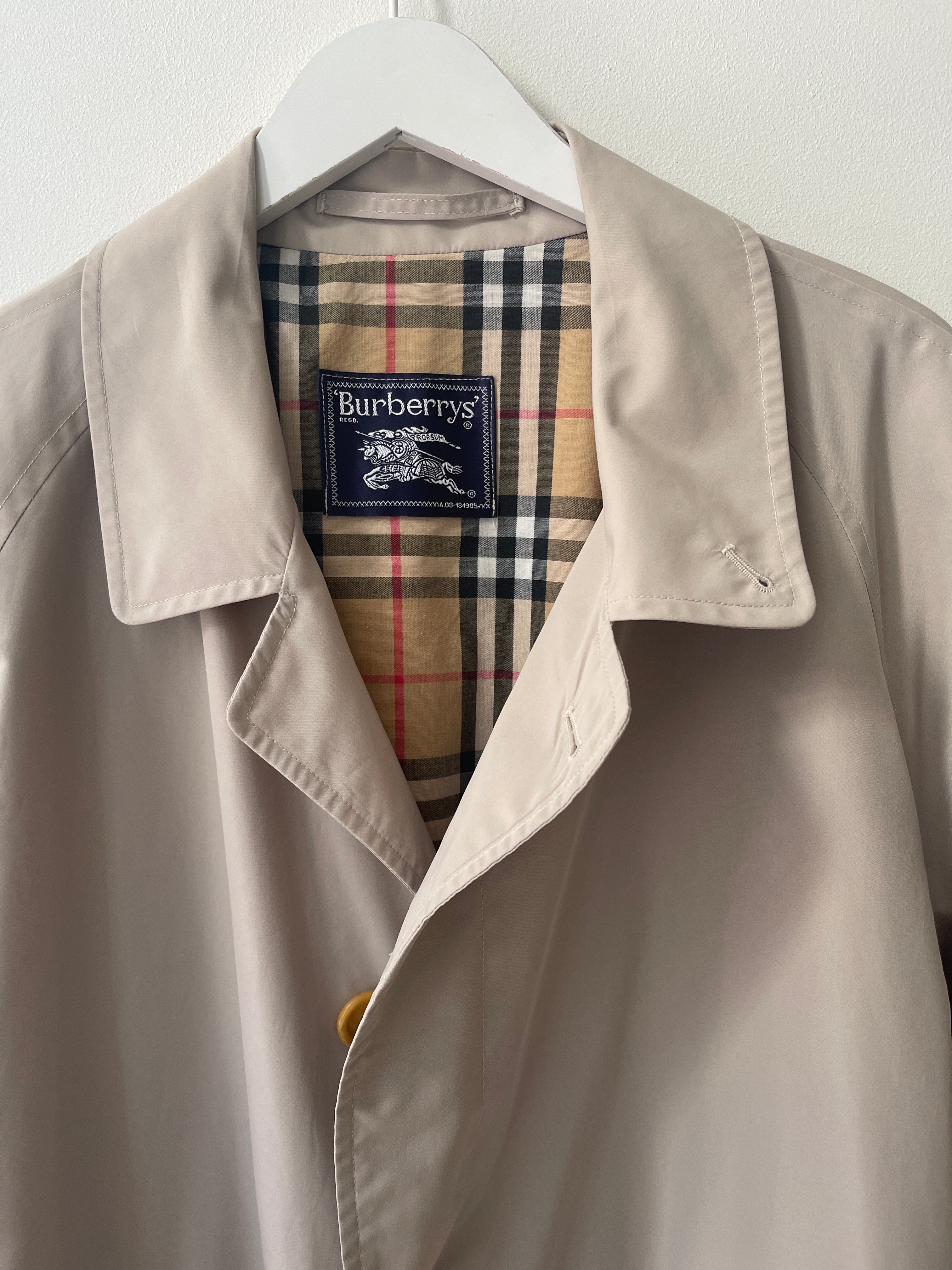 Sand colour belted Burberry trench coat.