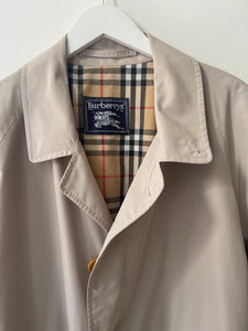 Sand colour belted Burberry trench coat.