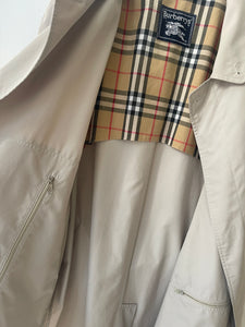 Sand colour belted Burberry trench coat.